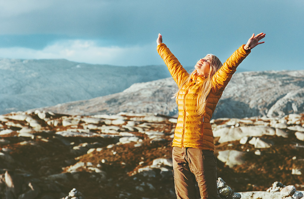 happy traveler on mountain peak